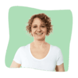 Smiling woman with curly hair wearing a white shirt, in front of a green abstract background